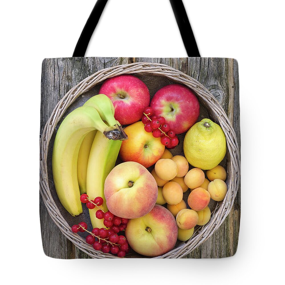 Red Currant Tote Bag featuring the photograph Basket Filled With Fruits, Close Up by Westend61