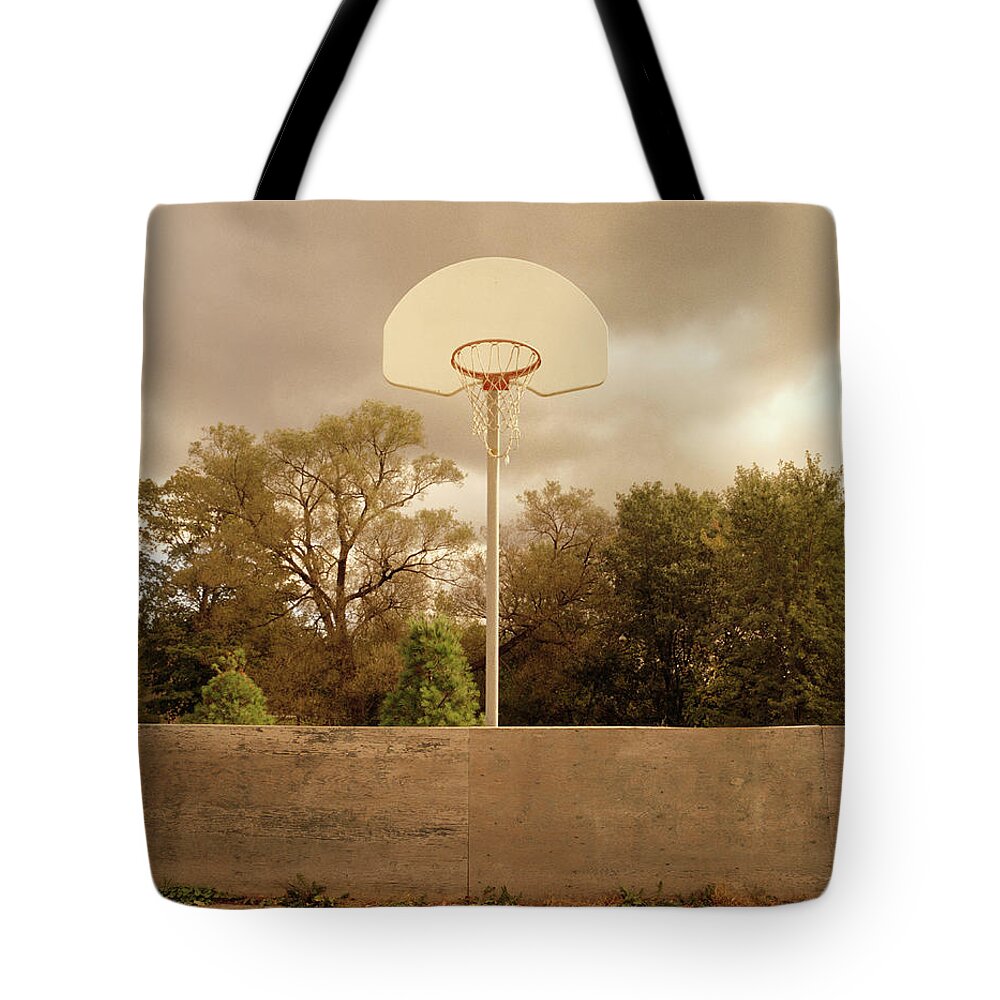 Suburb Tote Bag featuring the photograph Basketball Backboard And Hoop Against by Chris Thomaidis