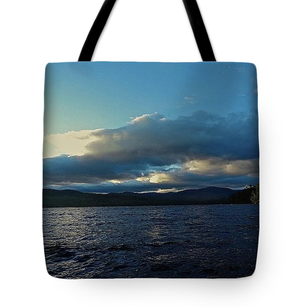 Water Tote Bag featuring the photograph Behind A Cloud by Alida M Haslett