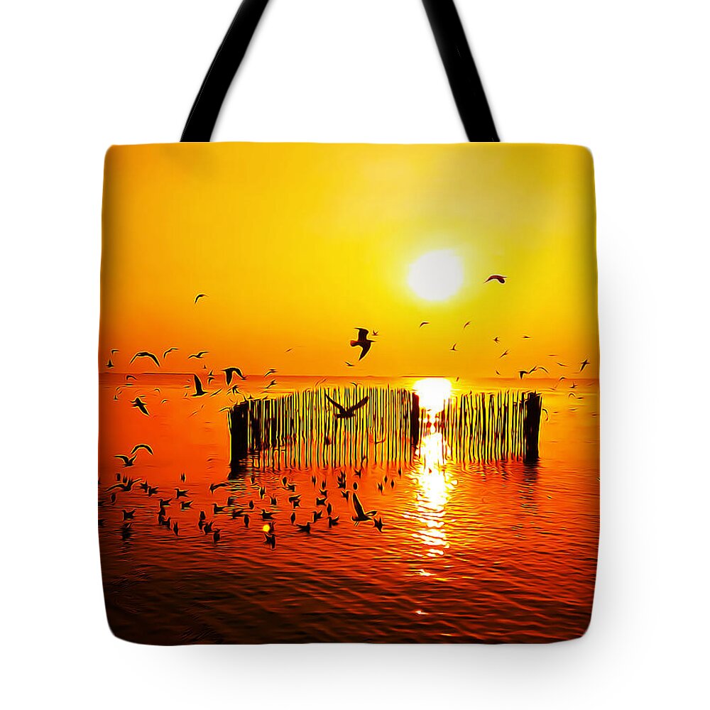 Sunset Tote Bag featuring the digital art Birds over the sea at sunset by Andrea Dalla Bona