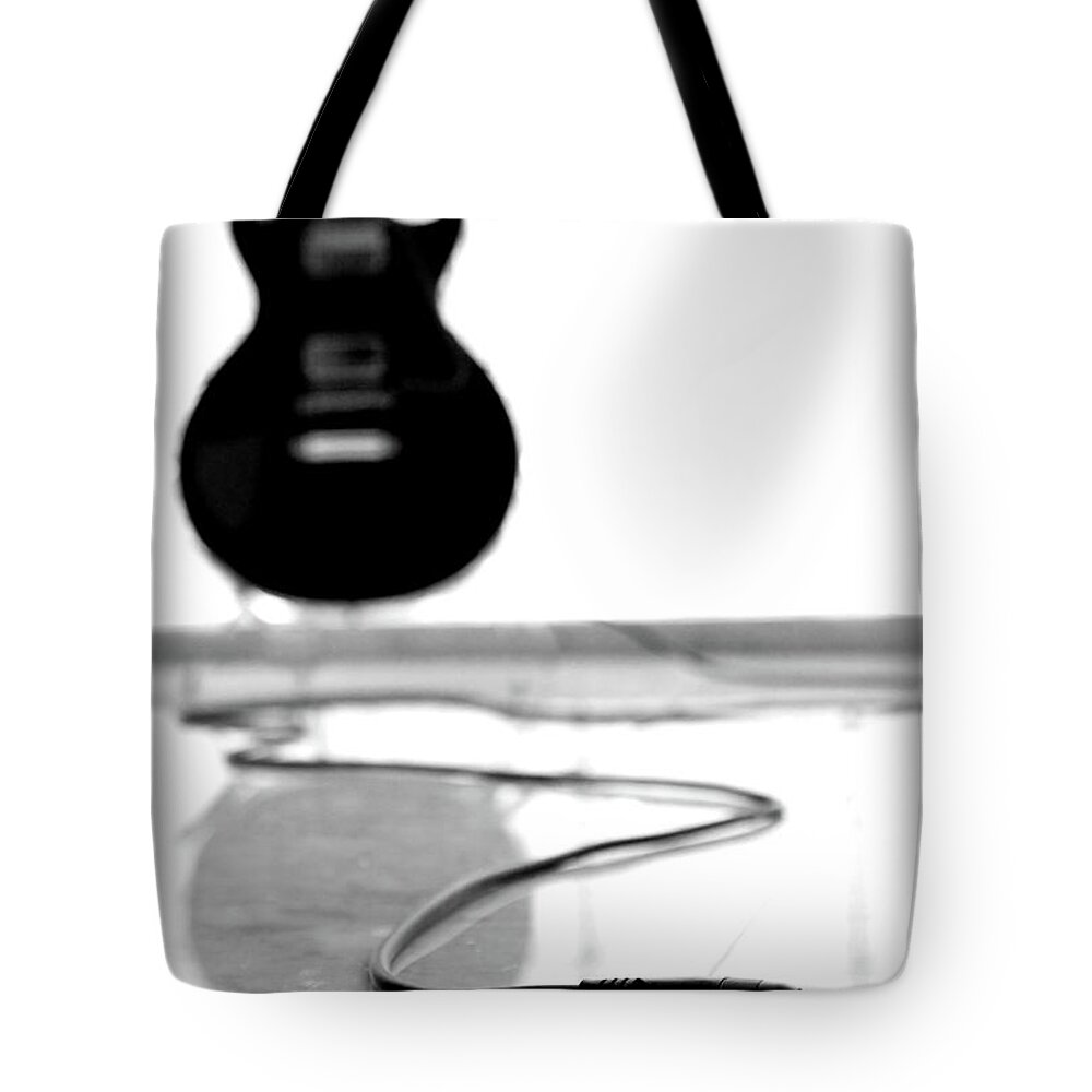 Rock Music Tote Bag featuring the photograph Black Guitar And Cord With Copy Spapce by Clickhere