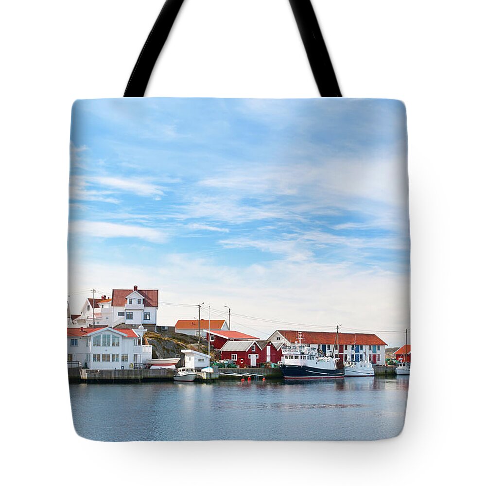 Water's Edge Tote Bag featuring the photograph Bohuslan Harbor Village by Martin Wahlborg