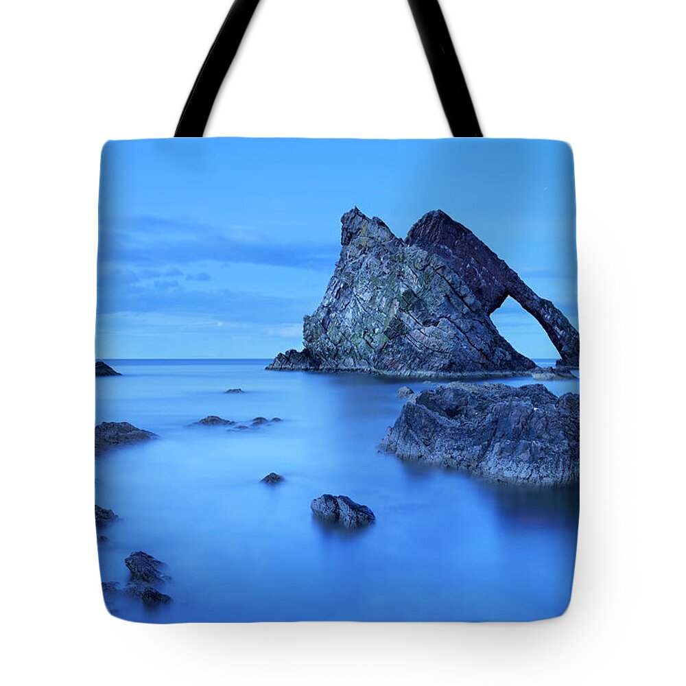 Water's Edge Tote Bag featuring the photograph Bow Fiddle Rock, Natural Arch On Moray by Sara winter