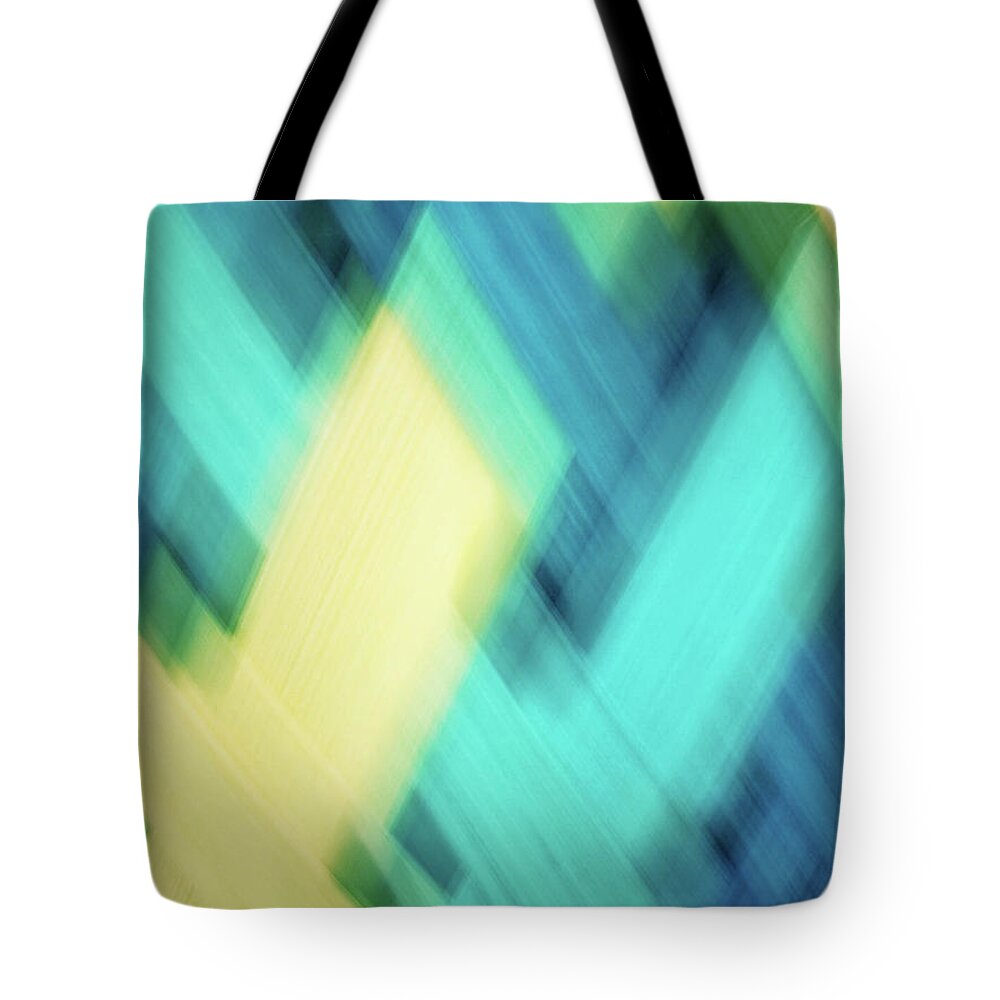 Abstract Tote Bag featuring the photograph Bright blue, turquoise, green and yellow blurred diamond shapes abstract by Teri Virbickis