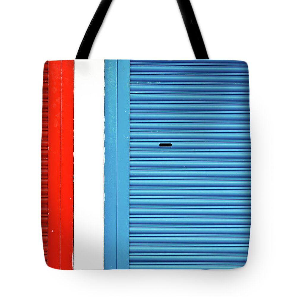 Outdoors Tote Bag featuring the photograph Bright Red And Blue Roller Shutters by M. Ivkovic - Bangphoto.co.uk