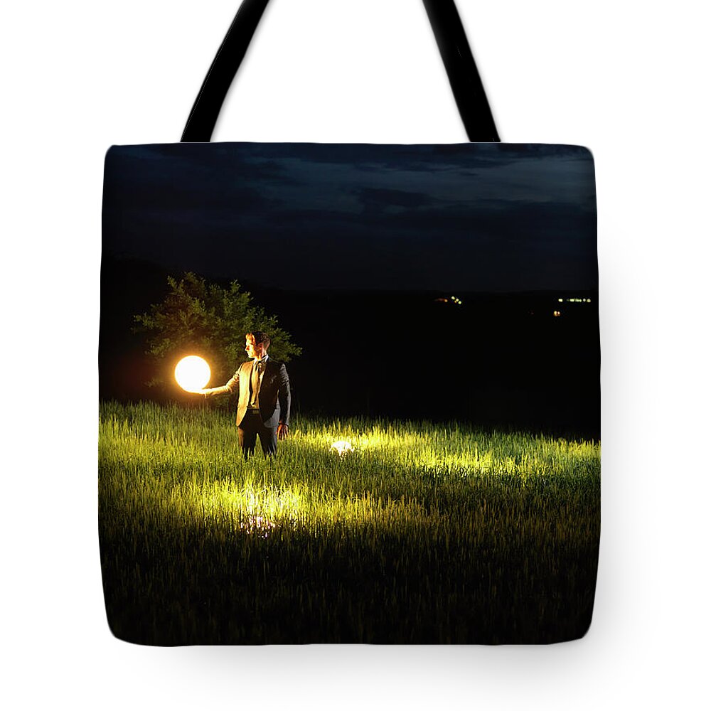 Corporate Business Tote Bag featuring the photograph Business Man Holding Up A Lamp by Raygun