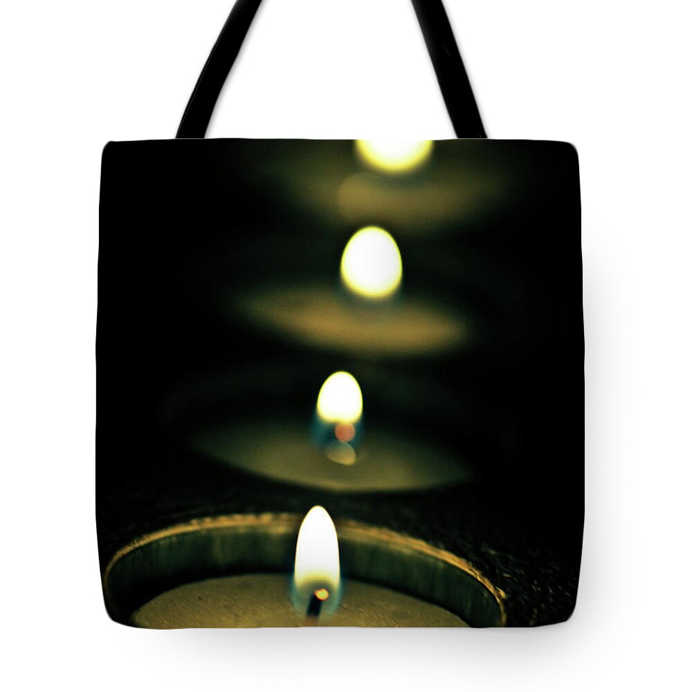 In A Row Tote Bag featuring the photograph Candles In A Church by Rafa Llano Instantaneas