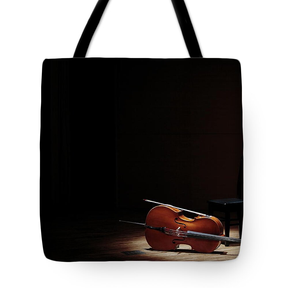 Tranquility Tote Bag featuring the photograph Cello And Chair On Stage by Sot