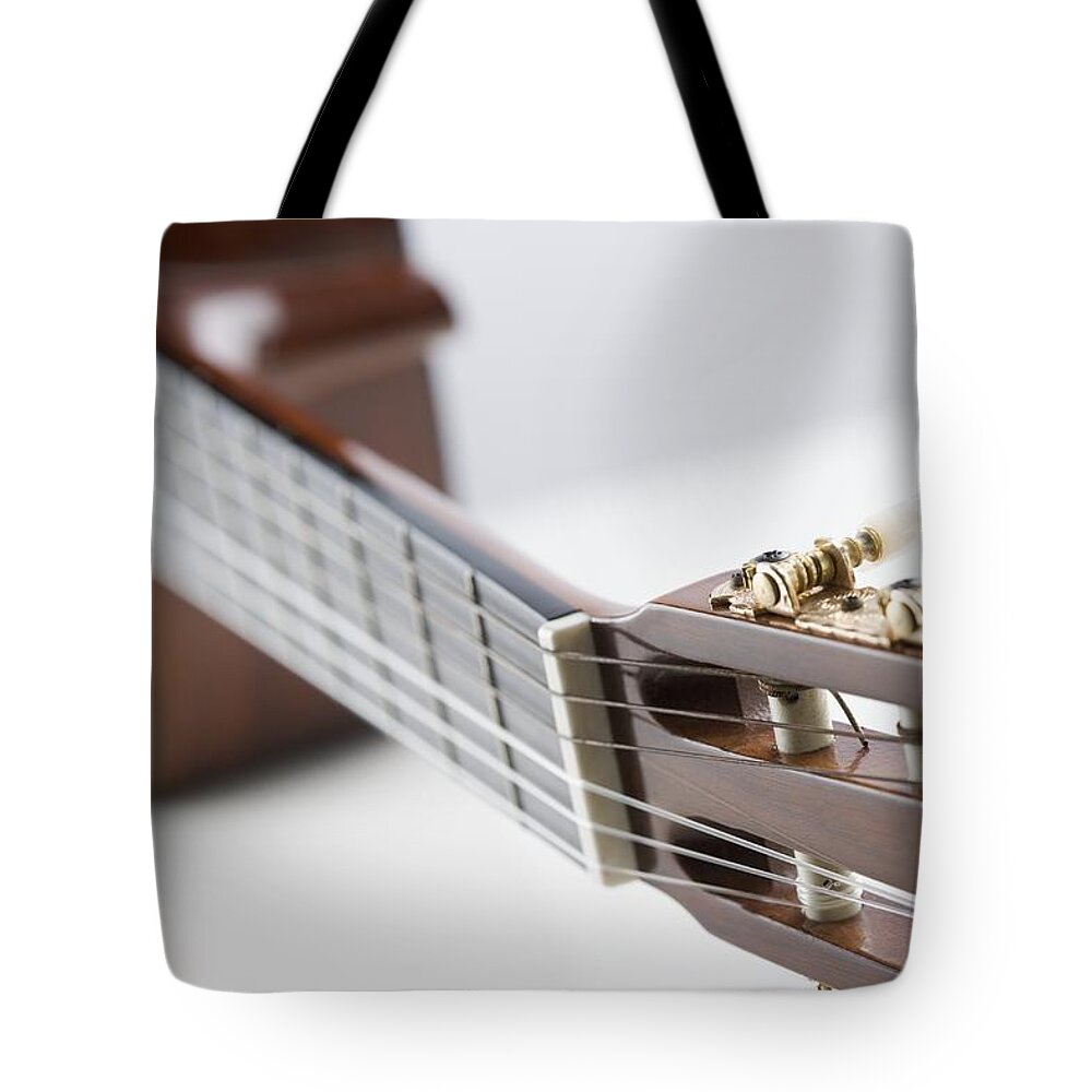 White Background Tote Bag featuring the photograph Close-up Of A Guitar by Jamie Grill
