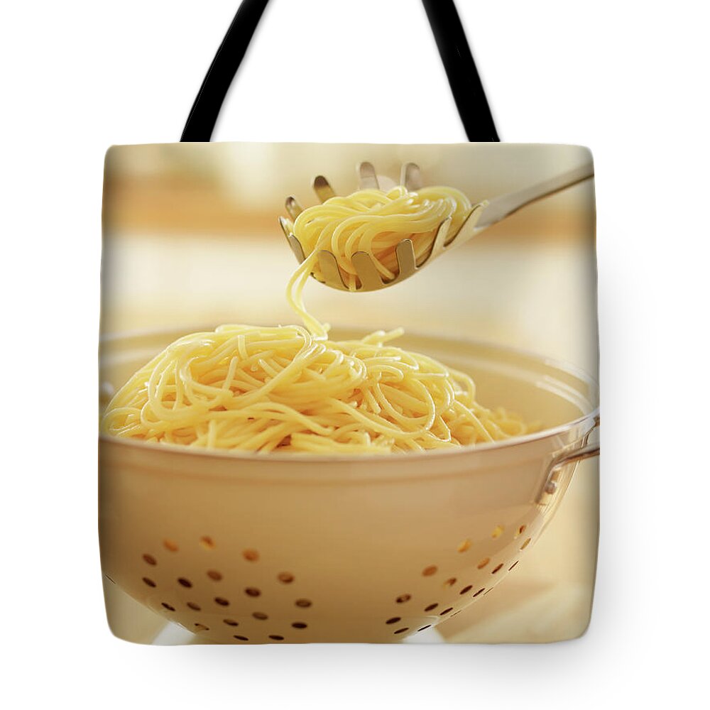 Italian Food Tote Bag featuring the photograph Close Up Of Spoon Scooping Spaghetti In by Adam Gault