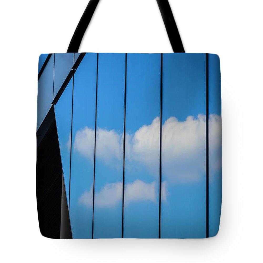 Berlin Tote Bag featuring the photograph Clouds Reflected In A Glass Facade by Ingo Jezierski