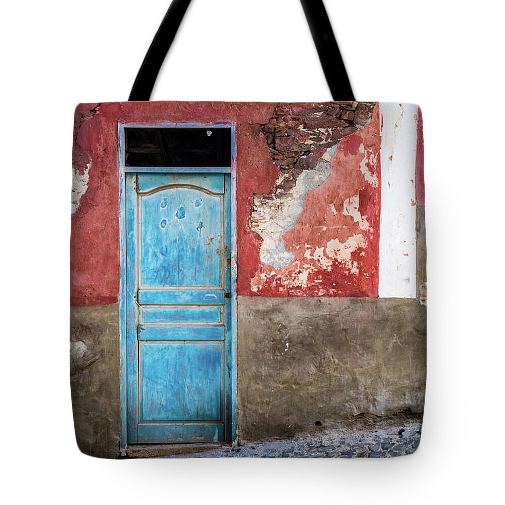Wall Tote Bag featuring the photograph Colorful wall with blue door by Lyl Dil Creations