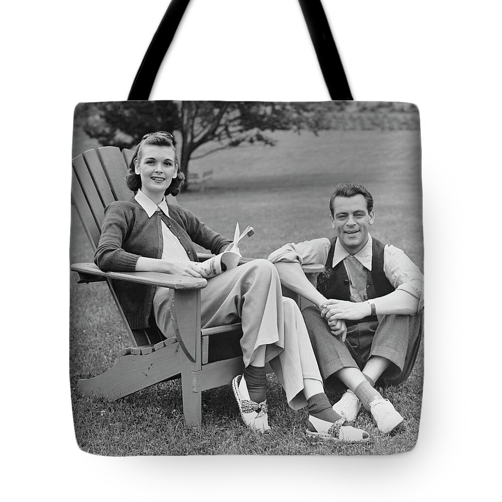Heterosexual Couple Tote Bag featuring the photograph Couple Sitting Outdoors by George Marks