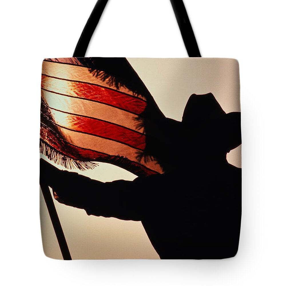 One Man Only Tote Bag featuring the photograph Cowboy Holding Stars And Stripes by Donovan Reese