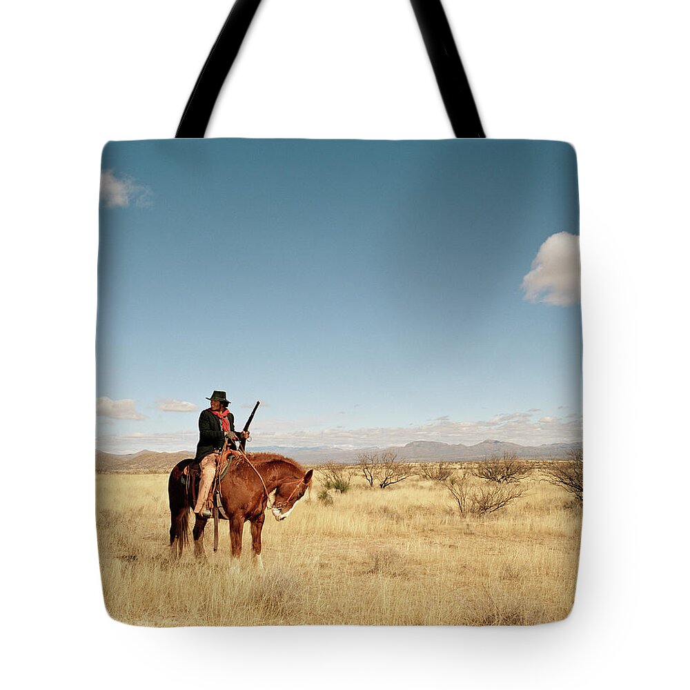 Horse Tote Bag featuring the photograph Cowboy Riding On Horse by Matthias Clamer
