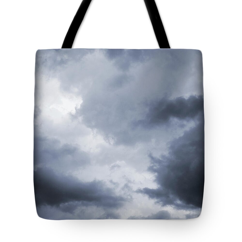 People Tote Bag featuring the photograph Dark And Dramatic Storm Clouds by Ranplett