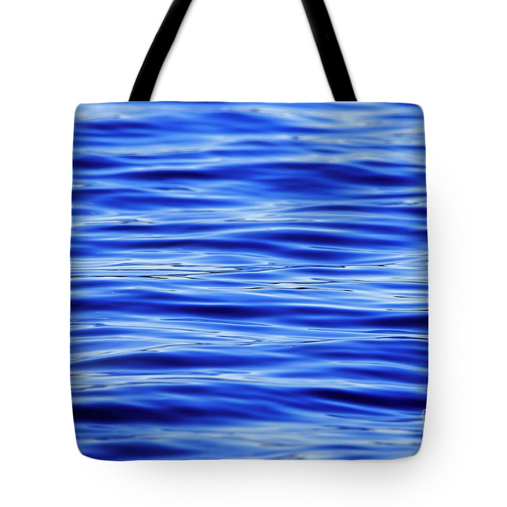 Blue Tote Bag featuring the photograph Dark Blue Water Ripples Background by Sandra J's