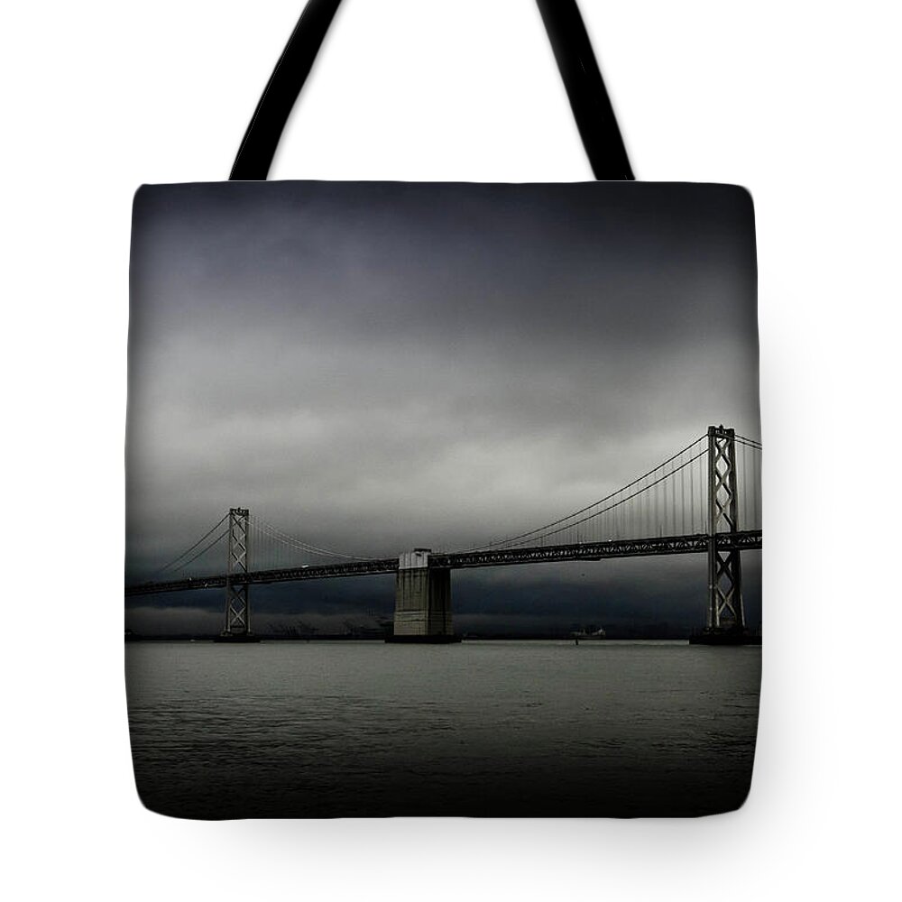 San Francisco Tote Bag featuring the photograph Dark Clouds Over Bay Bridge by Image Courtesy Of Sean Go