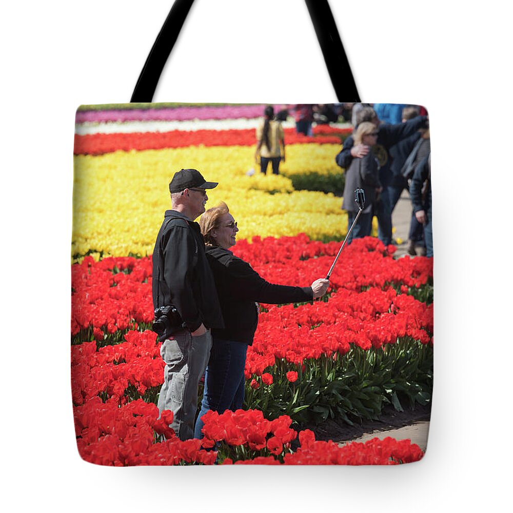 Double Selfie In Tulips Tote Bag featuring the photograph Double Selfie in Tulips by Tom Cochran