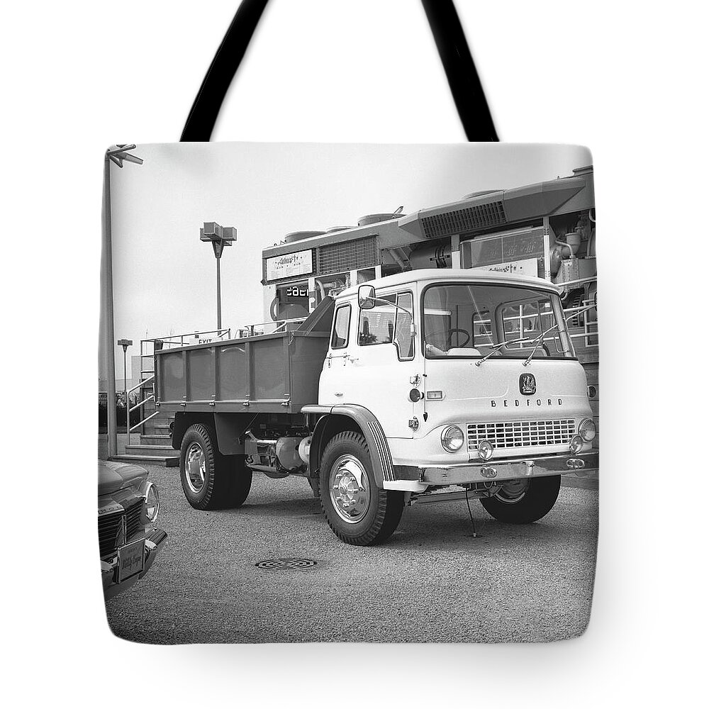 Freight Transportation Tote Bag featuring the photograph Dump Truck On Parking Lot, B&w by George Marks