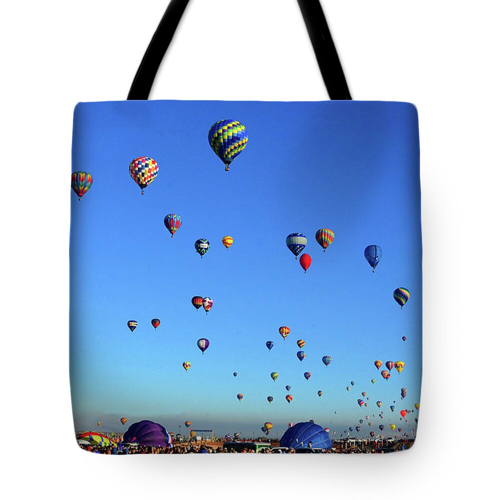 Albuquerque International Balloon Fiesta Tote Bag featuring the photograph Early morning lift off by David Lee Thompson