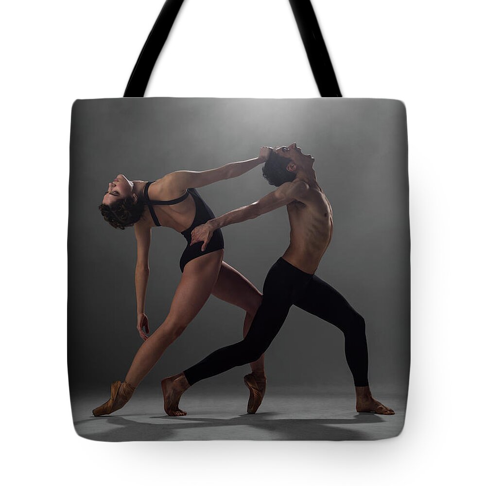 Ballet Dancer Tote Bag featuring the photograph Female And Male Ballet Dancers Arched by Nisian Hughes
