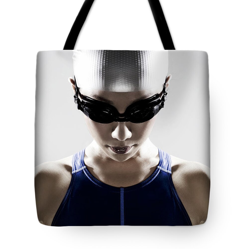 People Tote Bag featuring the photograph Female Swimmer Wearing Swim Cap And by Ting Hoo