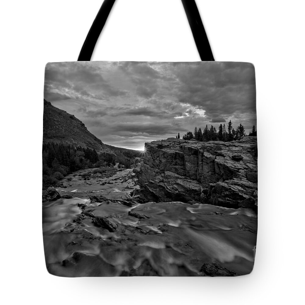 Swiftcurrent Falls Tote Bag featuring the photograph First Sunlight Over Swiftcurrent Falls Black And White by Adam Jewell