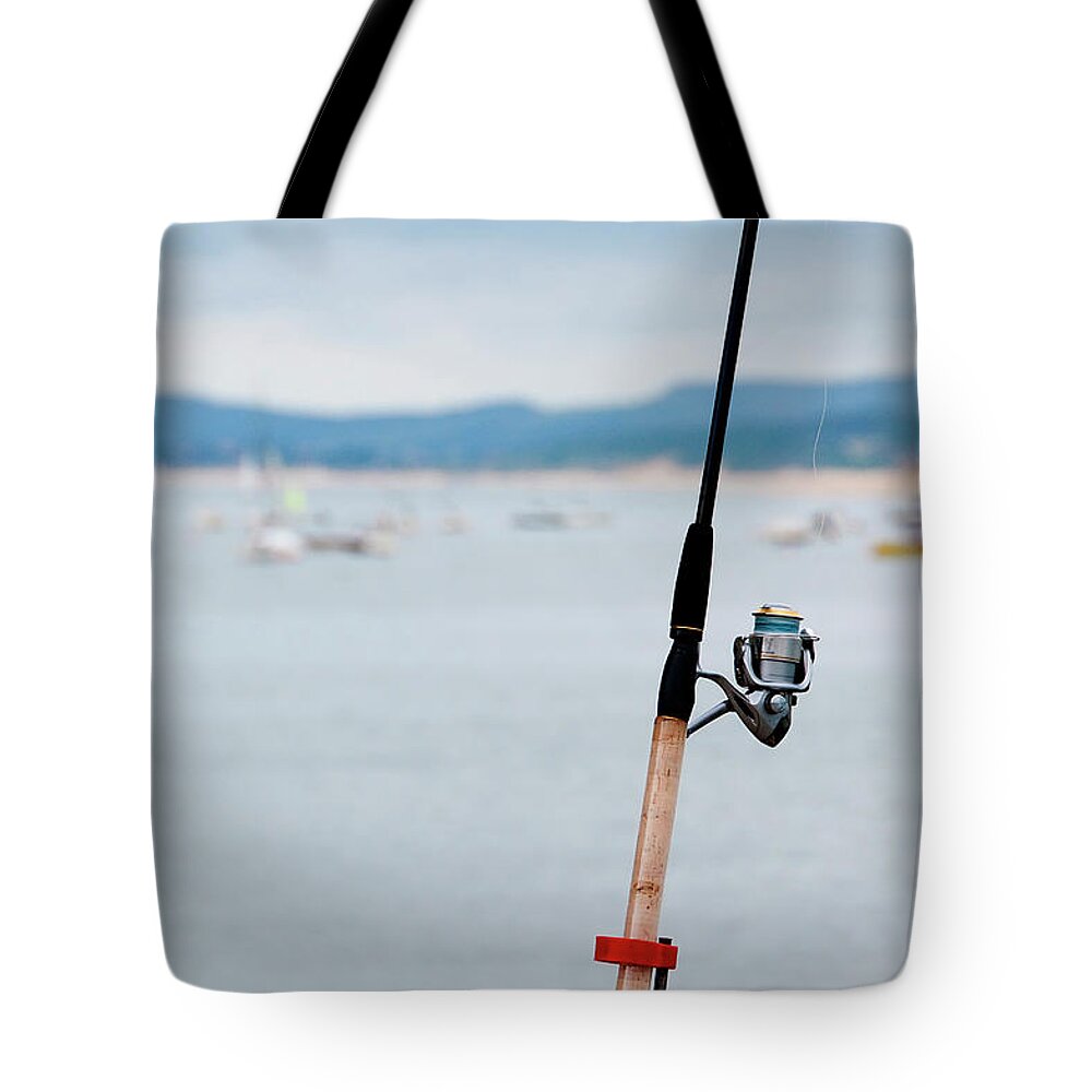 Outdoors Tote Bag featuring the photograph Fishing Rod by Sebastian Condrea