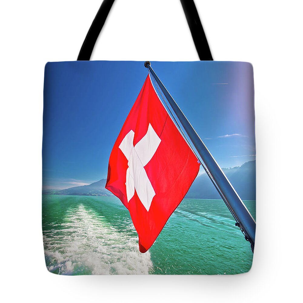 Luzern Tote Bag featuring the photograph Flowing on idyllic Swiss lake Lucerne boat flag view by Brch Photography