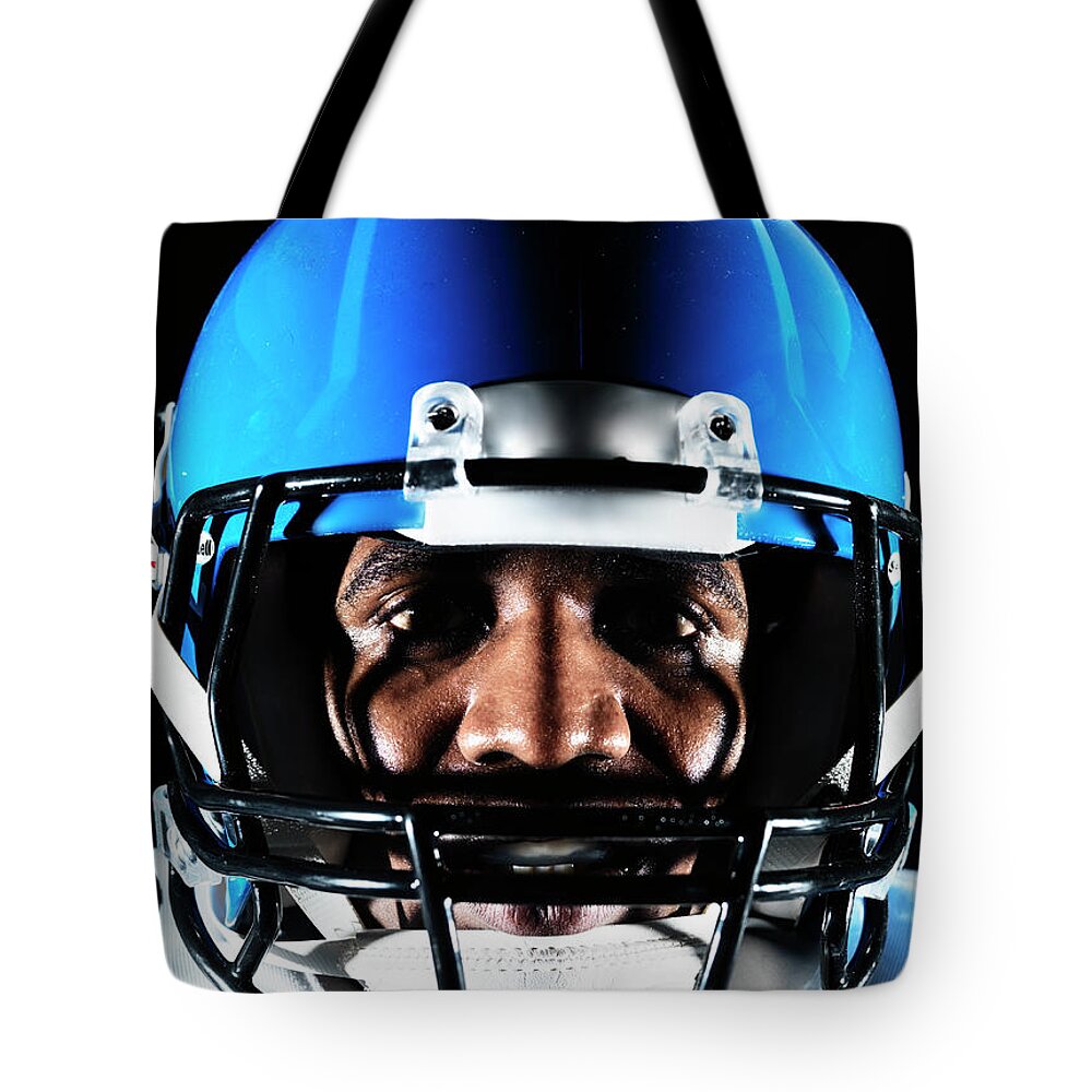 Toughness Tote Bag featuring the photograph Football Player by Henrik Sorensen