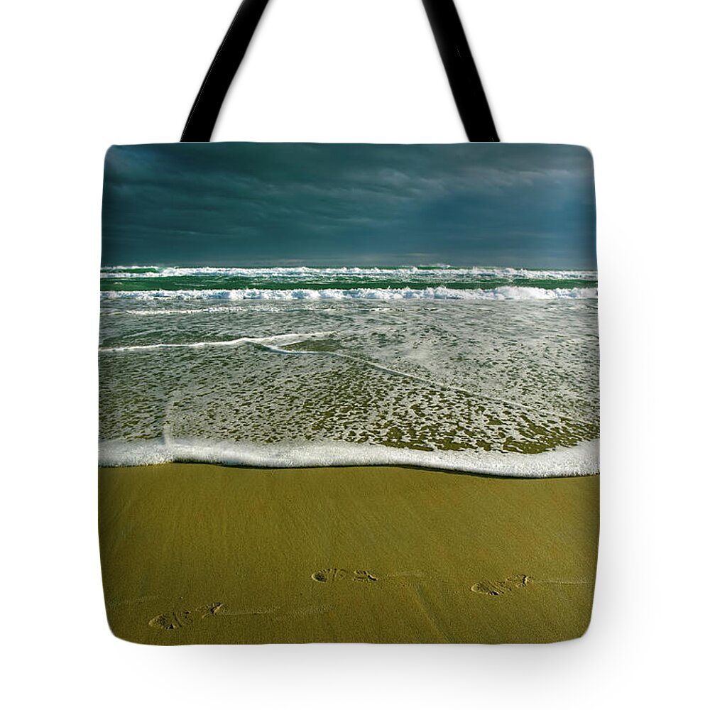 Water's Edge Tote Bag featuring the photograph Footsteps And Storm Light by Jill Ferry