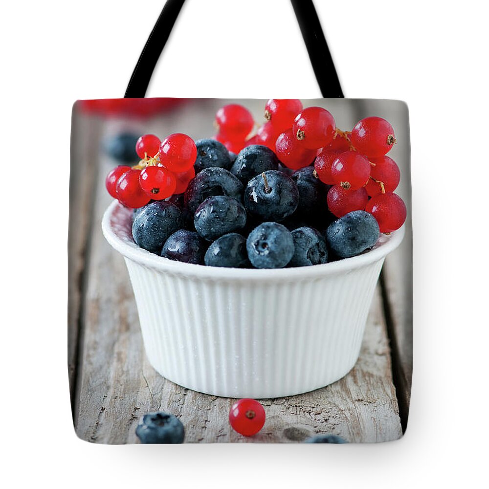 Black Color Tote Bag featuring the photograph Fresh Berry by Oxana Denezhkina