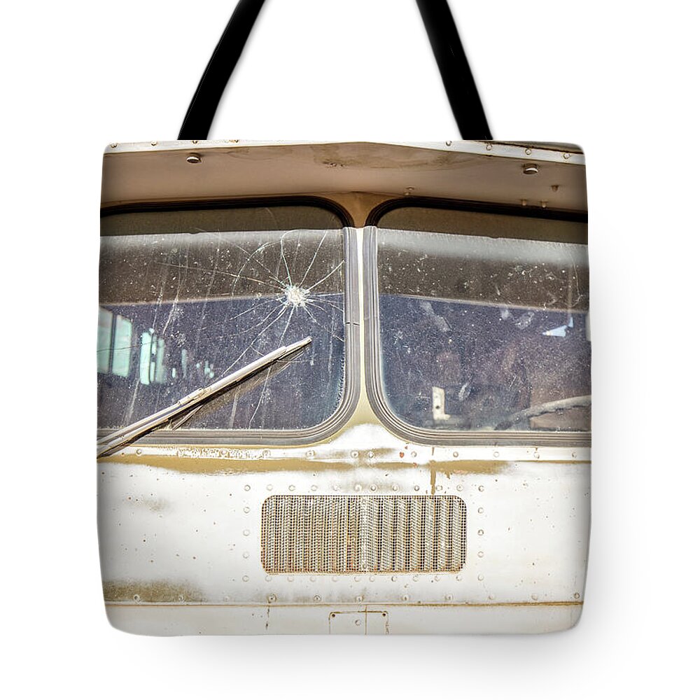 Junkyard Tote Bag featuring the photograph Front of an old Bus in a junkyard by Edward Fielding
