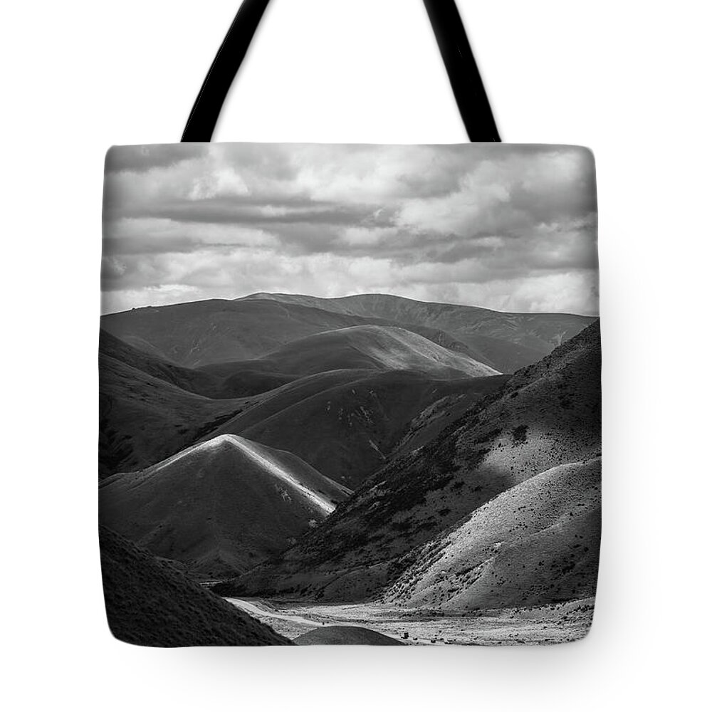 #nofilter #blackandwhite #newzealand #landscape #mountain #hills #clouds #cloudy #dark #light Tote Bag featuring the photograph Glimpses Of Light by Itto Ogami