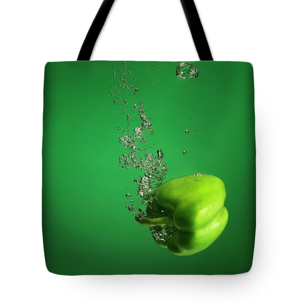 Copenhagen Tote Bag featuring the photograph Green Pebber Fruit Splashed Into Water by Henrik Sorensen