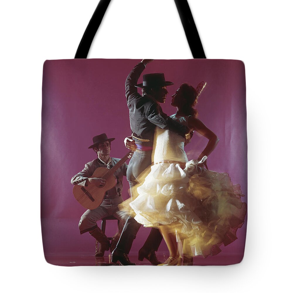 Hand Raised Tote Bag featuring the photograph Guitarist Playing Guitar And Couple by Tom Kelley Archive