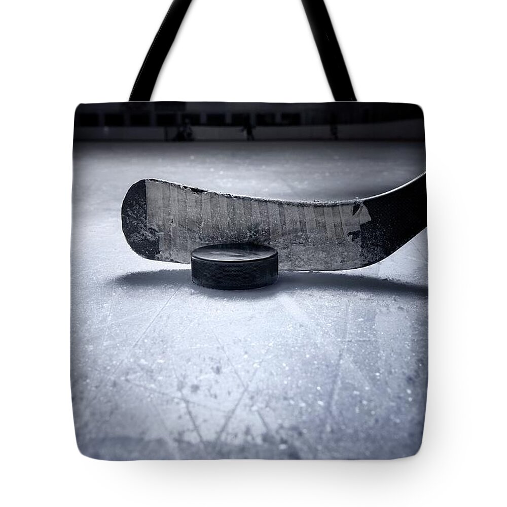 Recreational Pursuit Tote Bag featuring the photograph Hockey Stick And Puck by Francisblack
