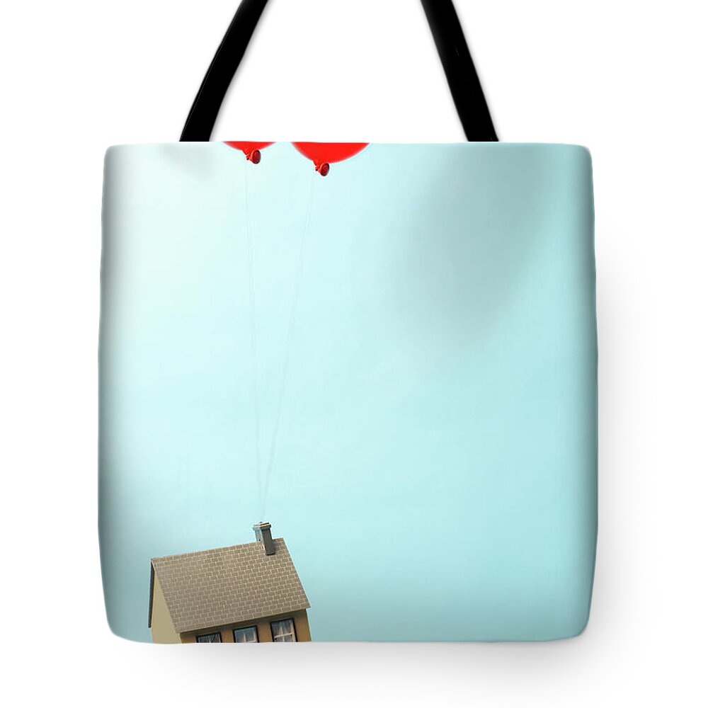 Model House Tote Bag featuring the photograph House Floating Away With Two Balloons by Peter Muller
