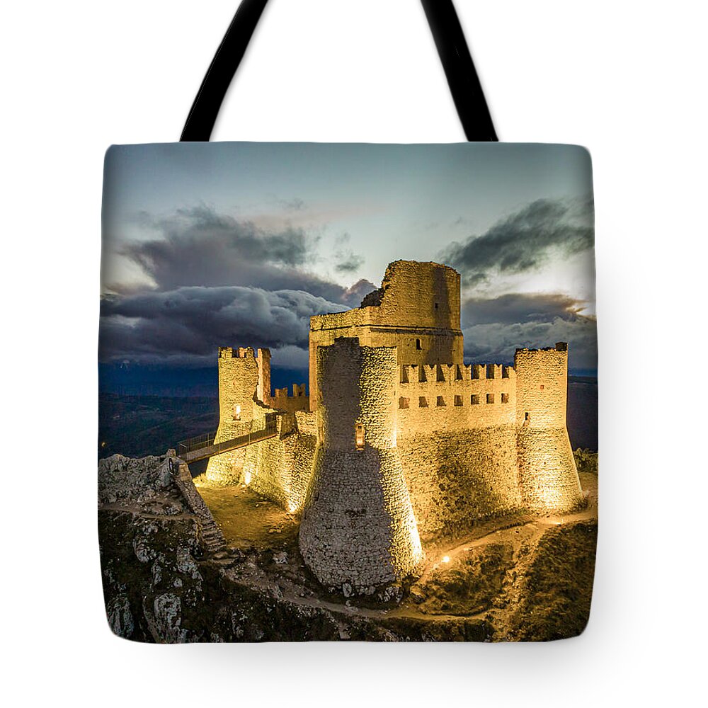 Estock Tote Bag featuring the digital art Italy, Abruzzo, L'aquila District, Apennines, Gran Sasso National Park, Calascio, Rocca Calascio Castle During The Blue Hour After Sunset, In The Gran Sasso National Park by Manfred Bortoli