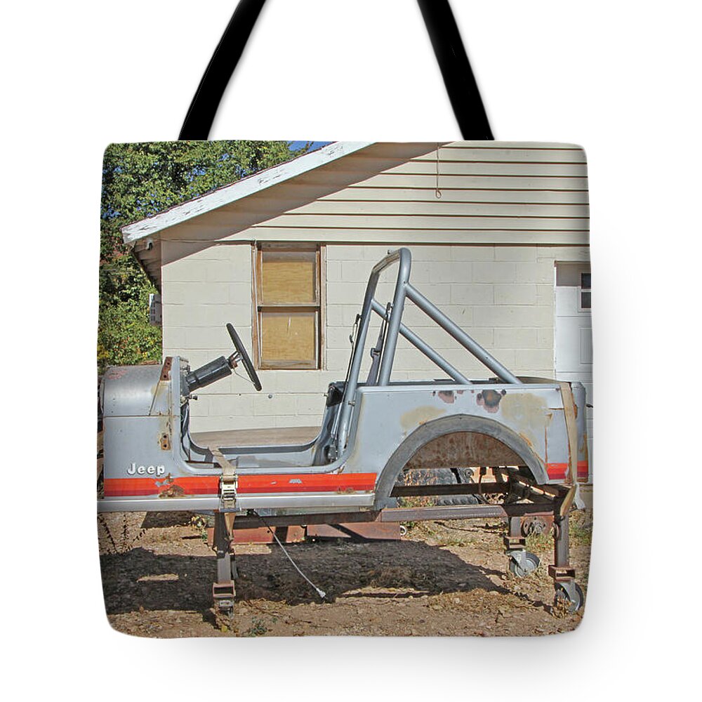 Kanab Jeep Needs A Little Work Perfect Starter Car For Teenager Car Garage Mountains Grays Red Strip Tote Bag featuring the photograph Kanab Jeep Needs a little work perfect starter car for teenager car garage mountains grays red strip by David Frederick