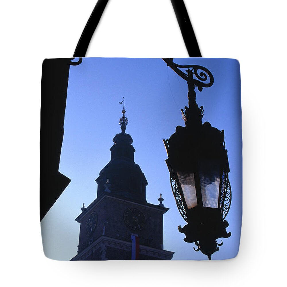 Outdoors Tote Bag featuring the photograph Lamp Post With Town Hall Tower Wieza by Lonely Planet