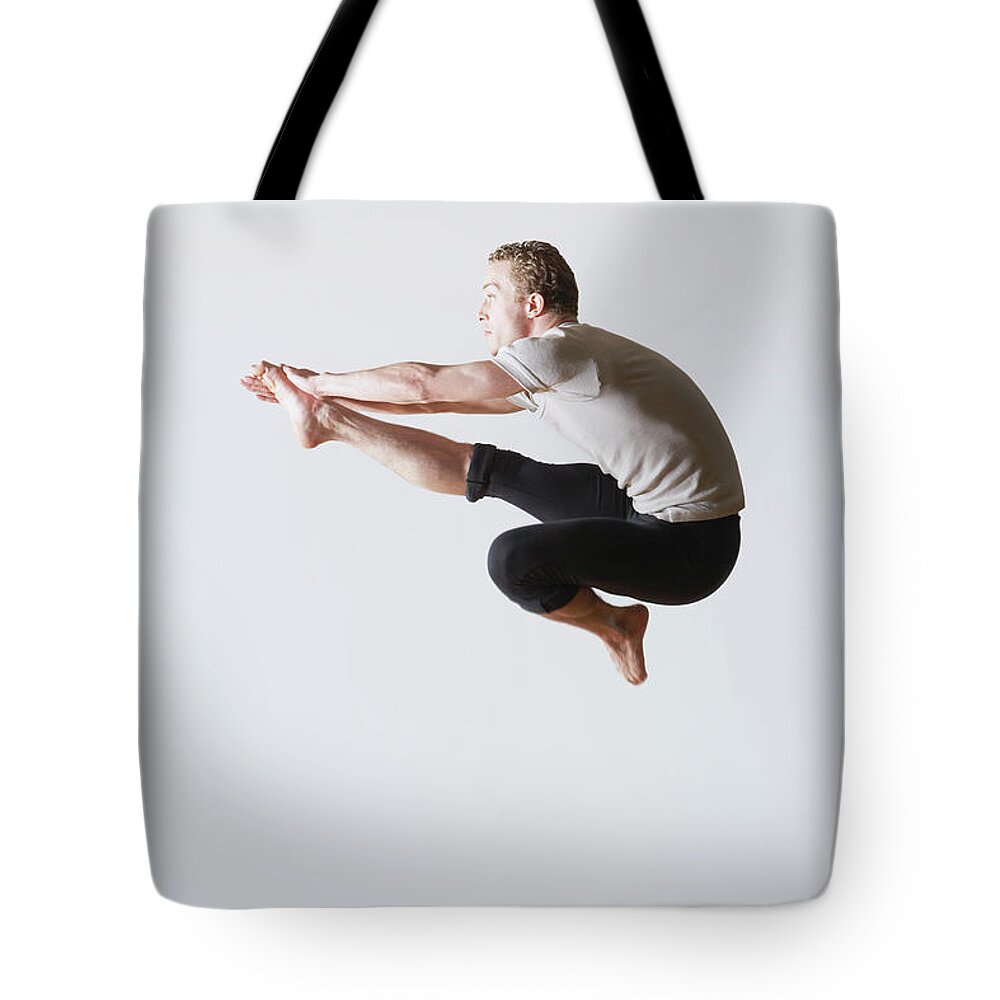 Ballet Dancer Tote Bag featuring the photograph Leaping Ballet Dancer In Mid-air by Moodboard - Mike Watson