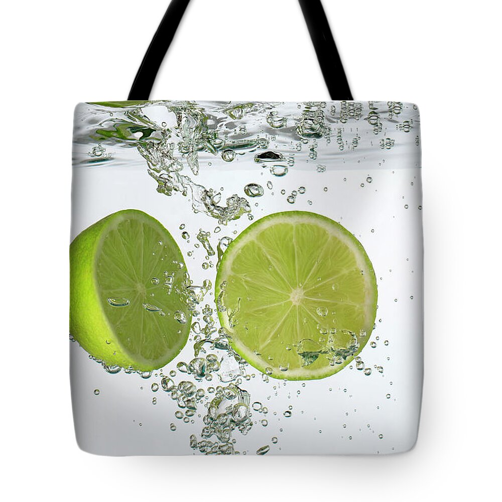 Vitamin C Tote Bag featuring the photograph Lime Halves Submerged In Water by Photoalto/neville Mountford-hoare