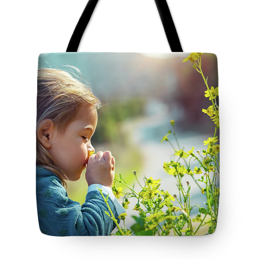 Active Tote Bag featuring the photograph Little boy enjoying flowers aroma by Anna Om