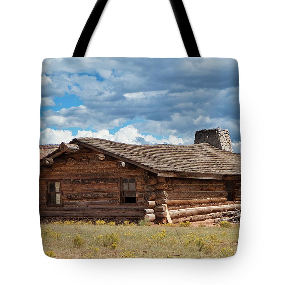Abiquiu Tote Bag featuring the photograph Log cabin at Ghost Ranch, Abiquiu NM by Segura Shaw Photography