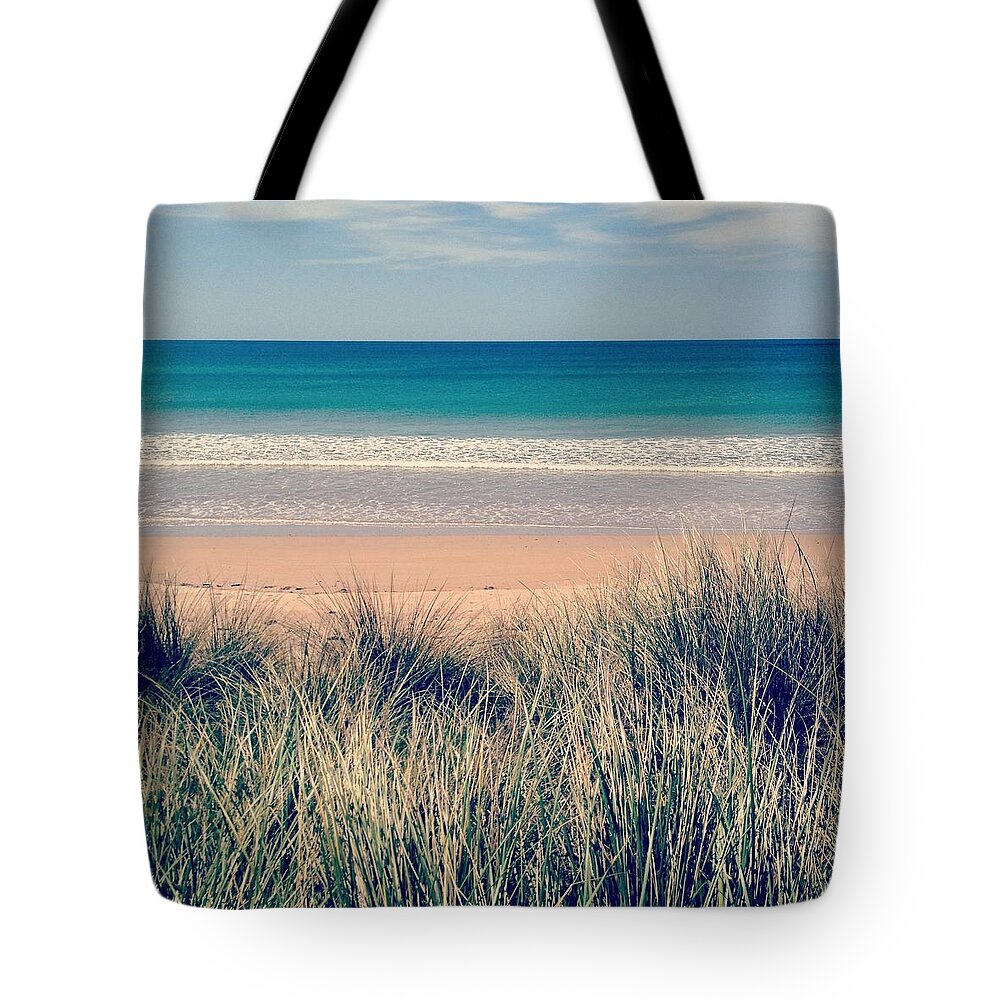 Water's Edge Tote Bag featuring the photograph Looking Over The Sea Grass Towards The by Jodie Griggs