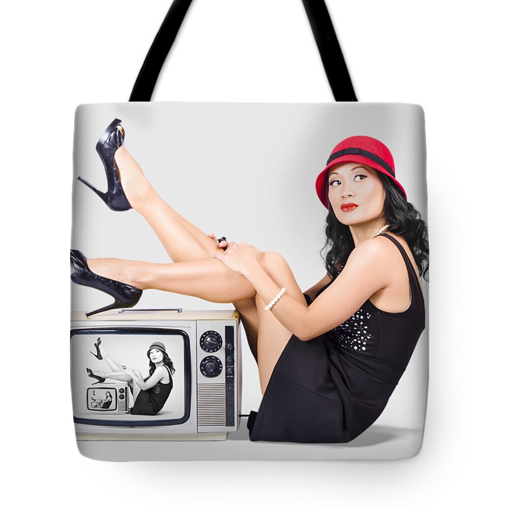 Girl Tote Bag featuring the photograph Lovely asian pinup girl posing on vintage tv set by Jorgo Photography
