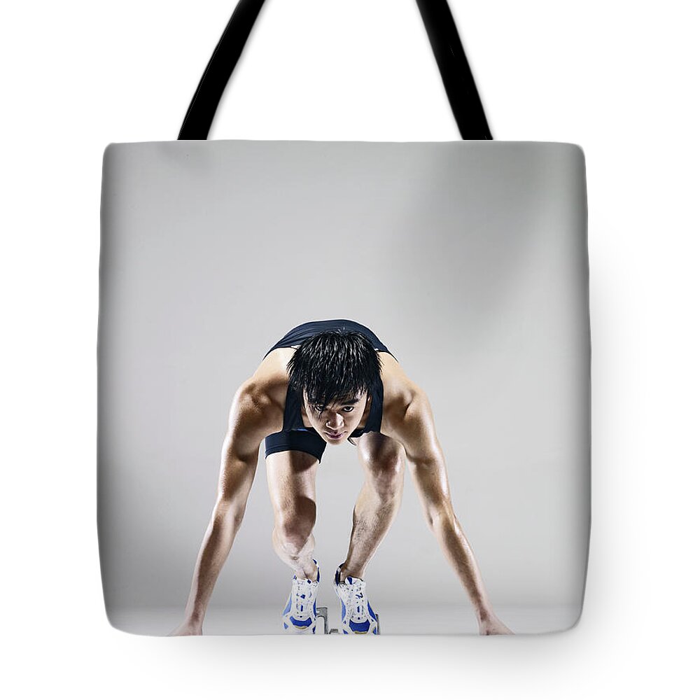 People Tote Bag featuring the photograph Male Runner In Starting Blocks by Ting Hoo