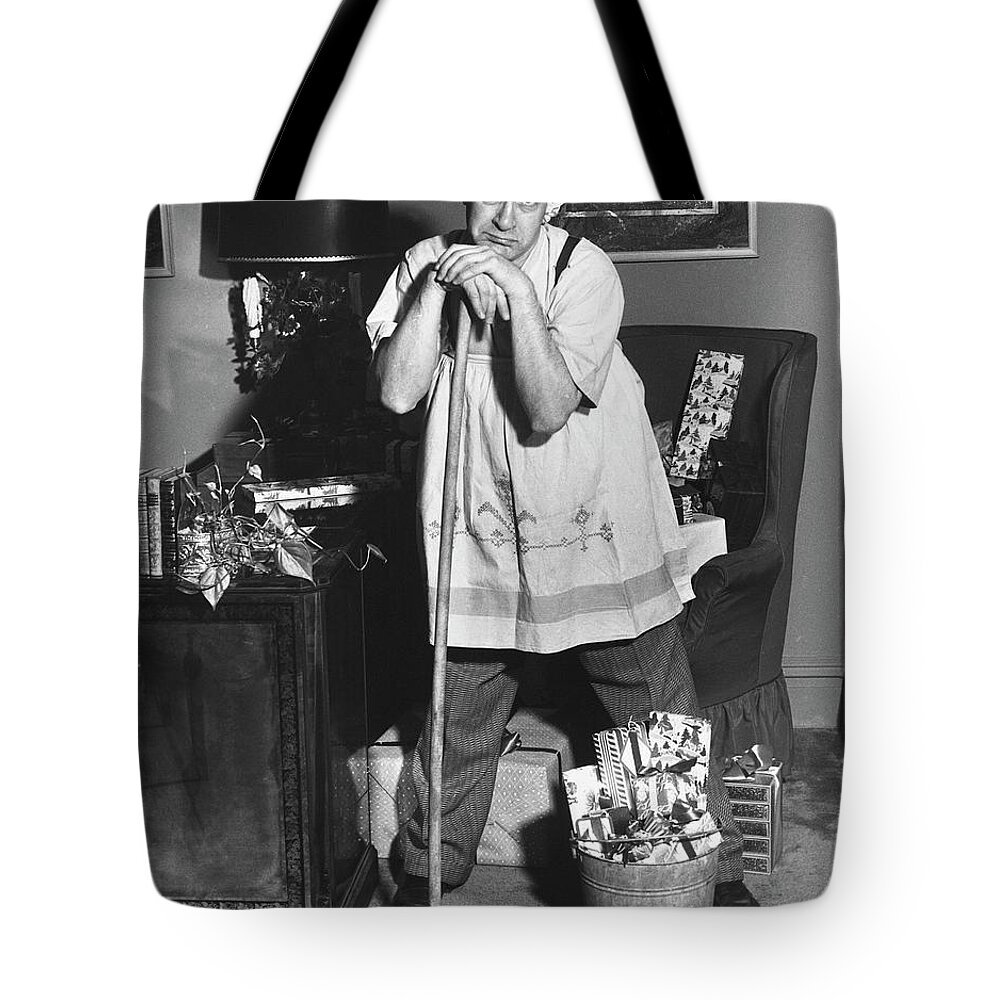 Working Tote Bag featuring the photograph Man Dressed As Cleaning Woman In Office by George Marks